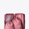 The Small Carry-On Roller in Wicked Pink